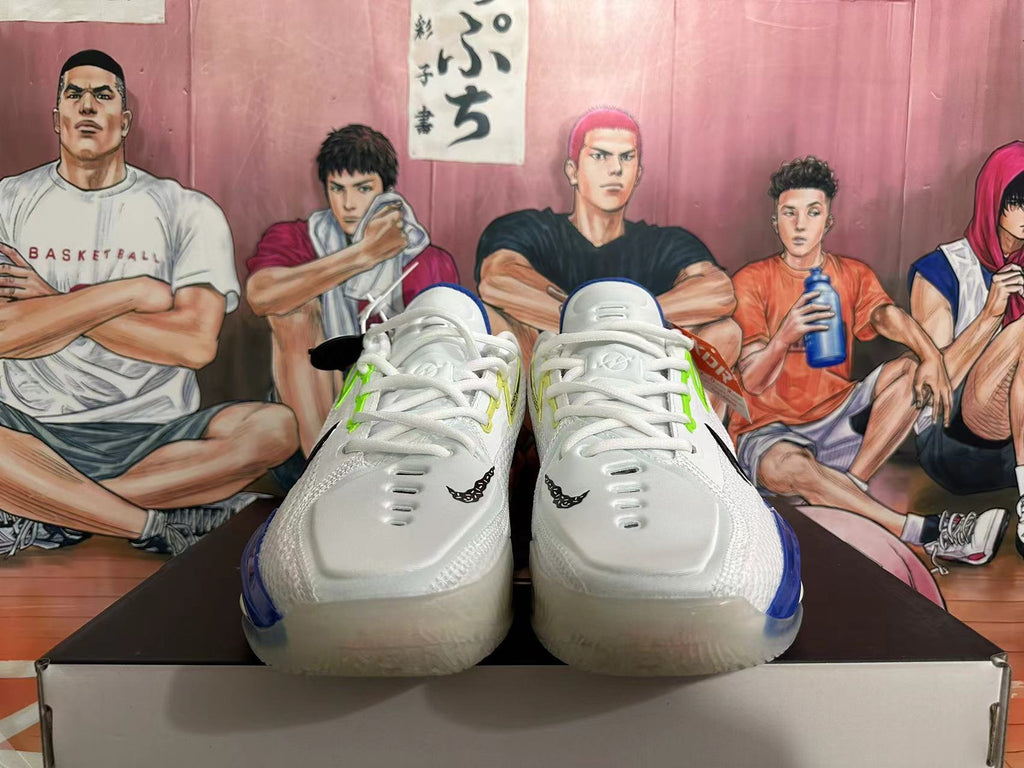 Front view of white Nike GT basketball shoes with white laces and blue accents.