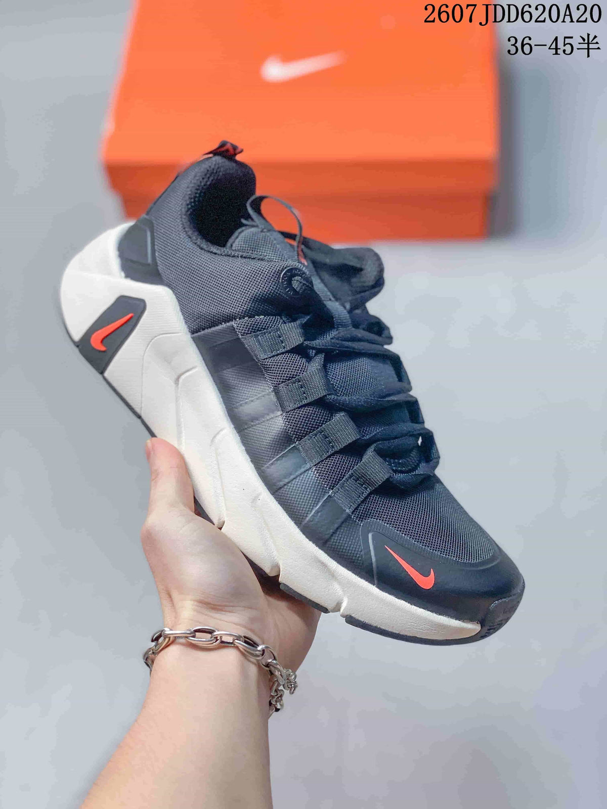 Black Nike Free Metcon 7-style training sneaker with a white segmented sole, red accents and layered side straps.
