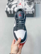 Top view showing black laces, a black tongue, and a perforated white toe box