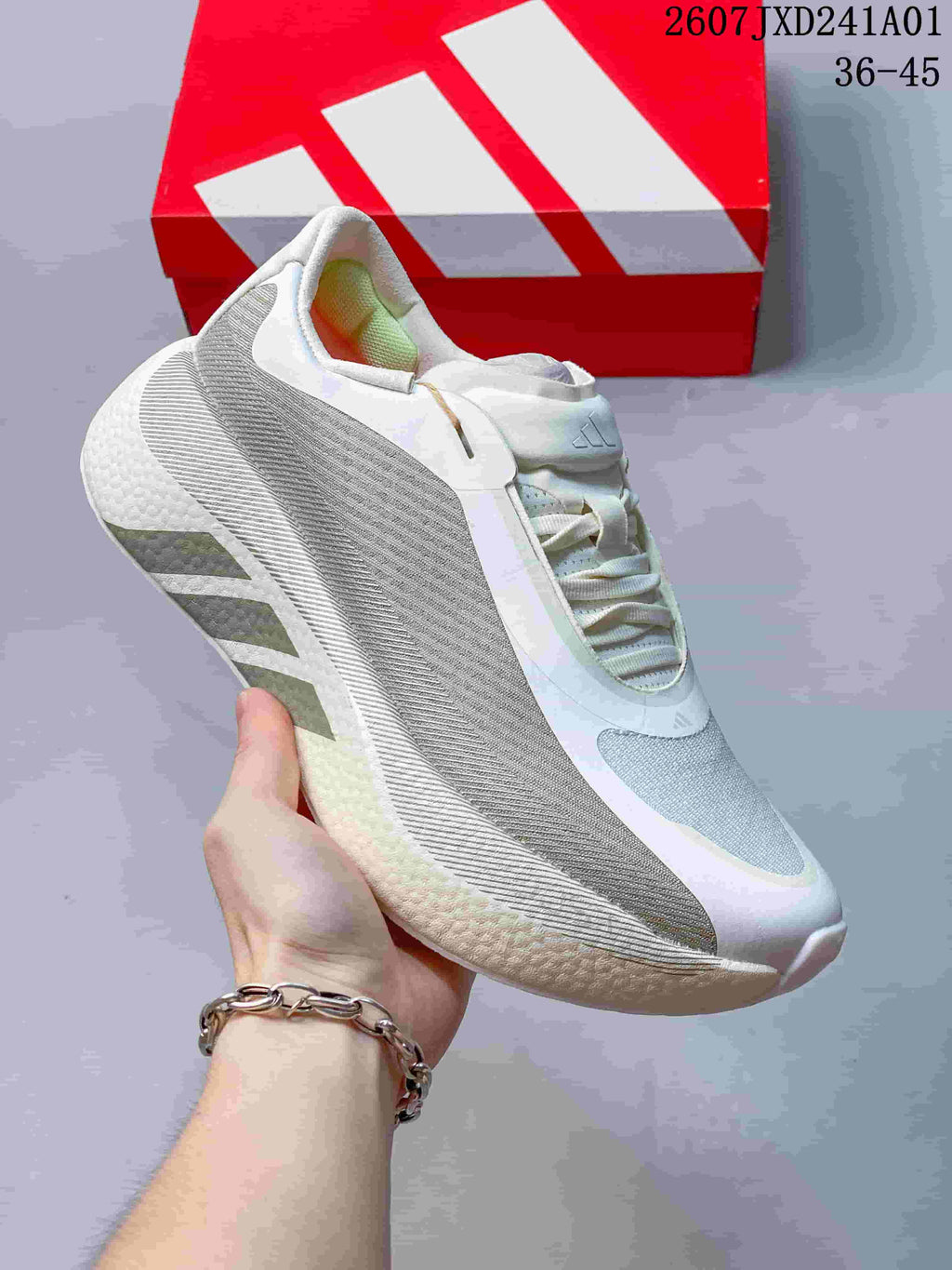 White and orange adidas Hyperboost Edge M running shoe shown from the side.