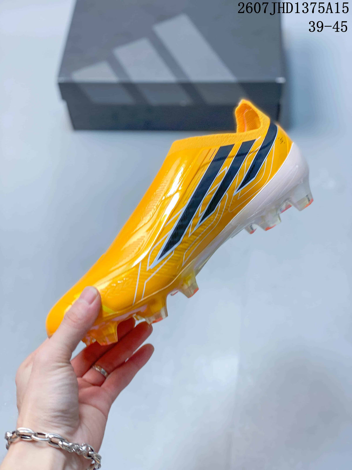 Side profile highlighting the yellow laceless upper, black side stripes, white graphics, and translucent stud outsole.