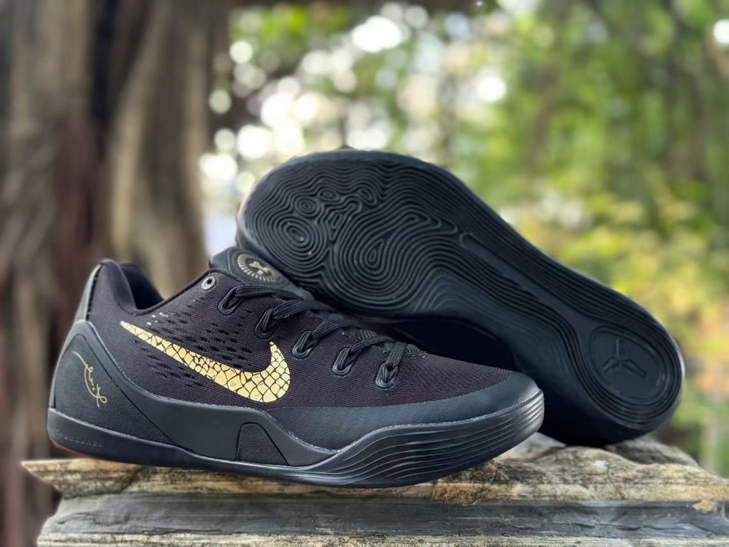 Black Kobe 9 shoe shown with its patterned outsole facing up.