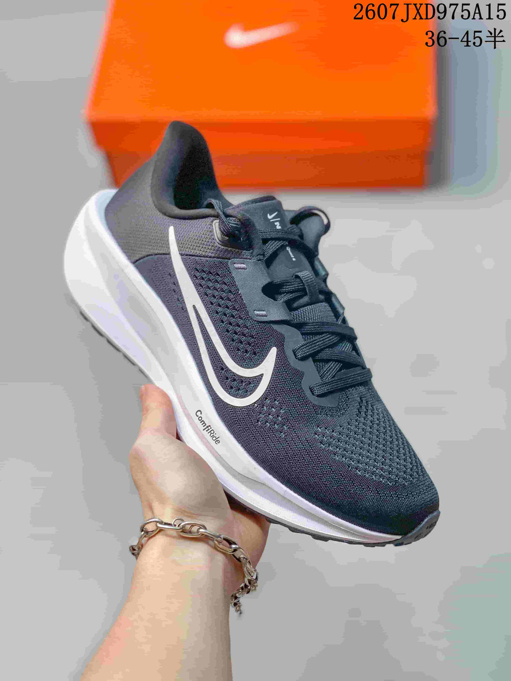 Angled side view showing the dark gray upper, white Swoosh, white midsole, and outsole.