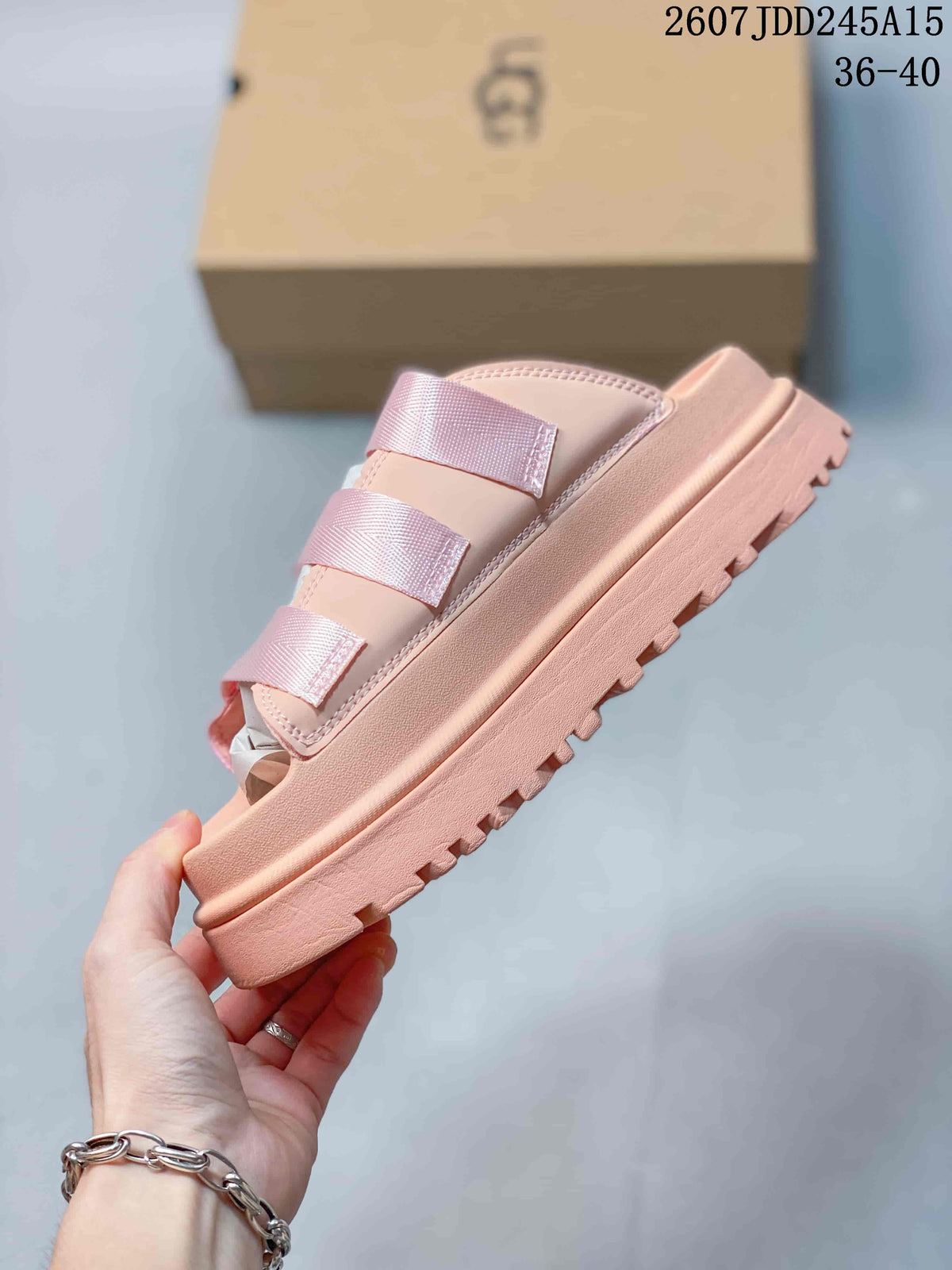 Side profile of the pink slide sandal showing its layered platform sole and textured tread.