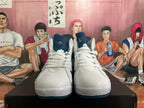 Front view of white and blue high-top sneakers with white laces and blue tongues