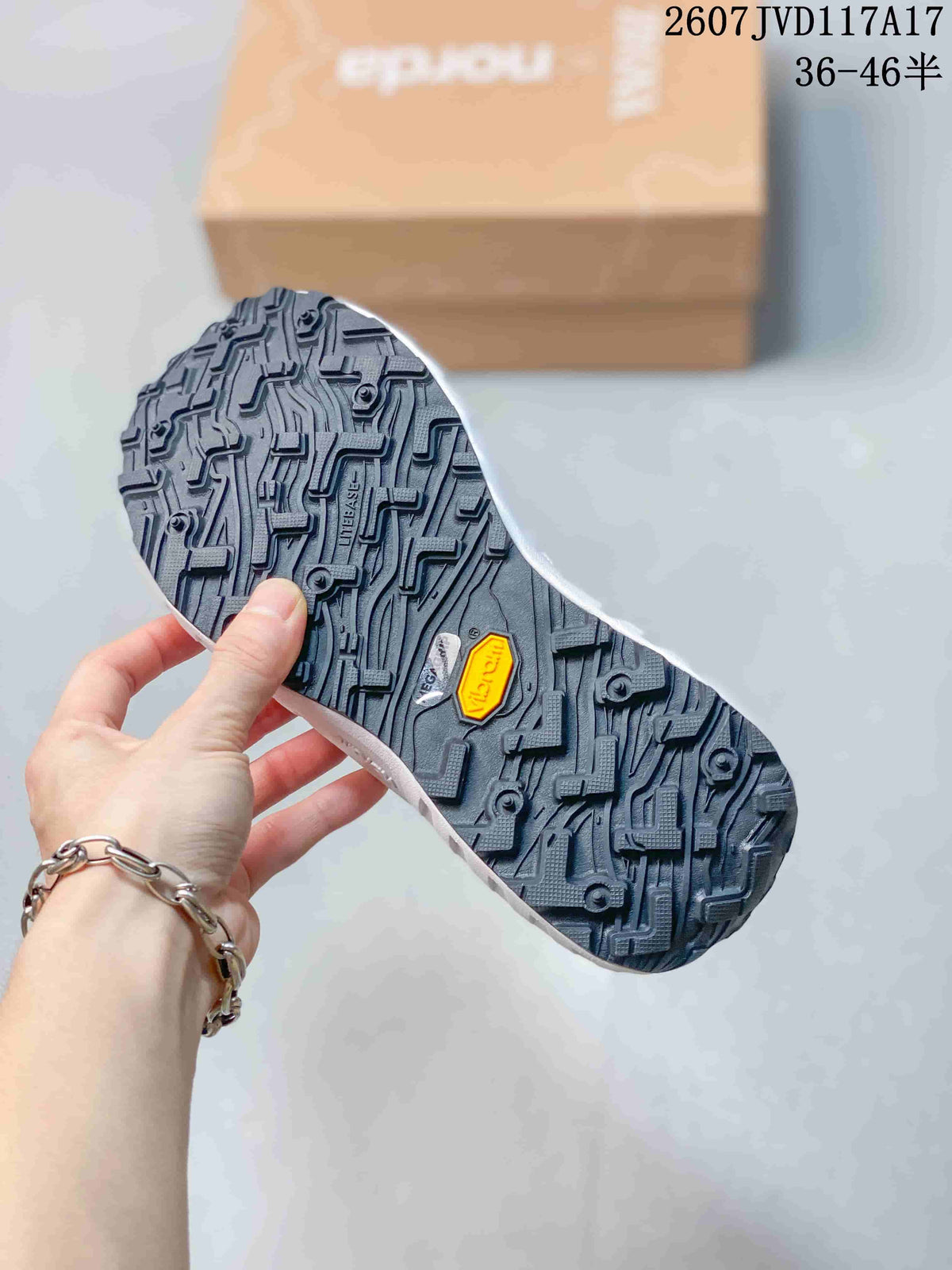 Close view of the black lugged outsole showing a patterned tread and visible Vibram branding.