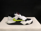 Lateral view highlighting the white heel, black upper panel, fluorescent green side detail, and black outsole.