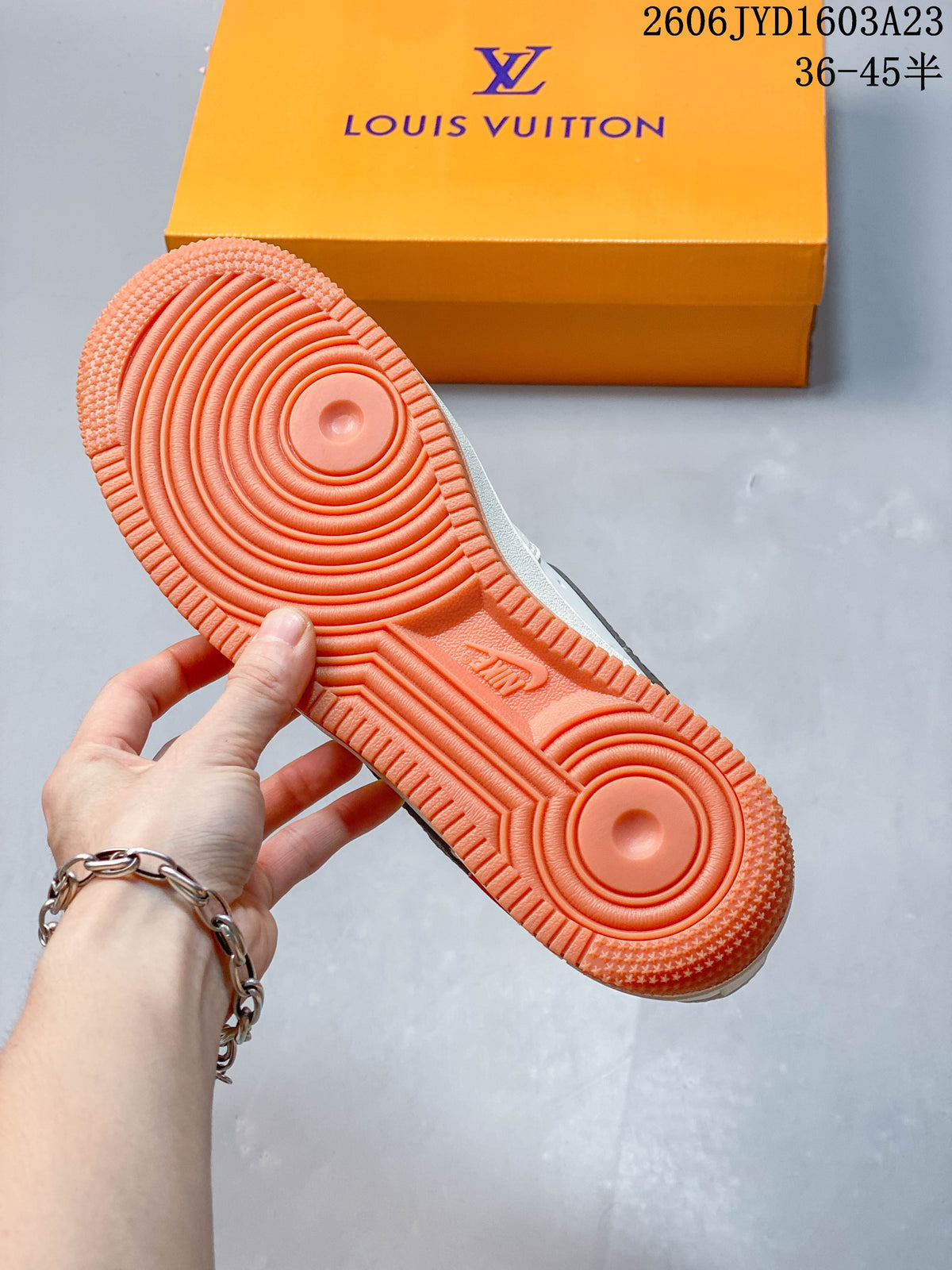 Underside view showing the gum-orange outsole and circular tread pattern