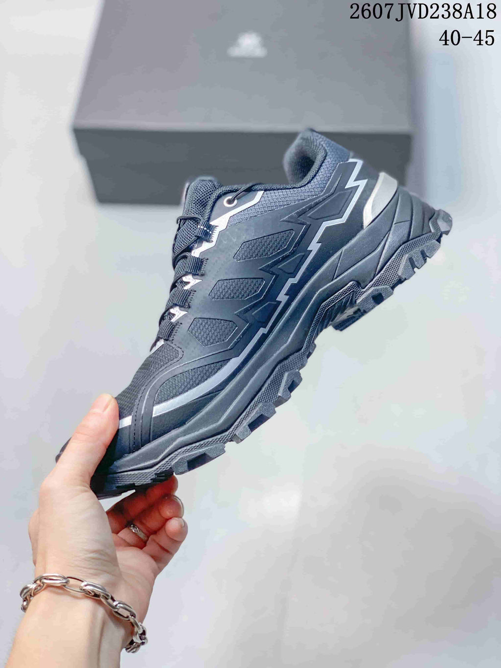 Side profile of the low-top hiking shoe showing angular overlays, contrasting accents, and a rugged outsole.
