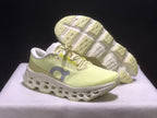 Three-quarter view of the sneakers with one shoe lifted to show the segmented outsole.
