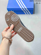 Close view of the textured gum-colored outsole with patterned tread on an Adidas Samba Jane shoe.