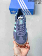 Top view showing the lace-up construction, padded collar, turquoise tongue branding, and contrasting toe panels.
