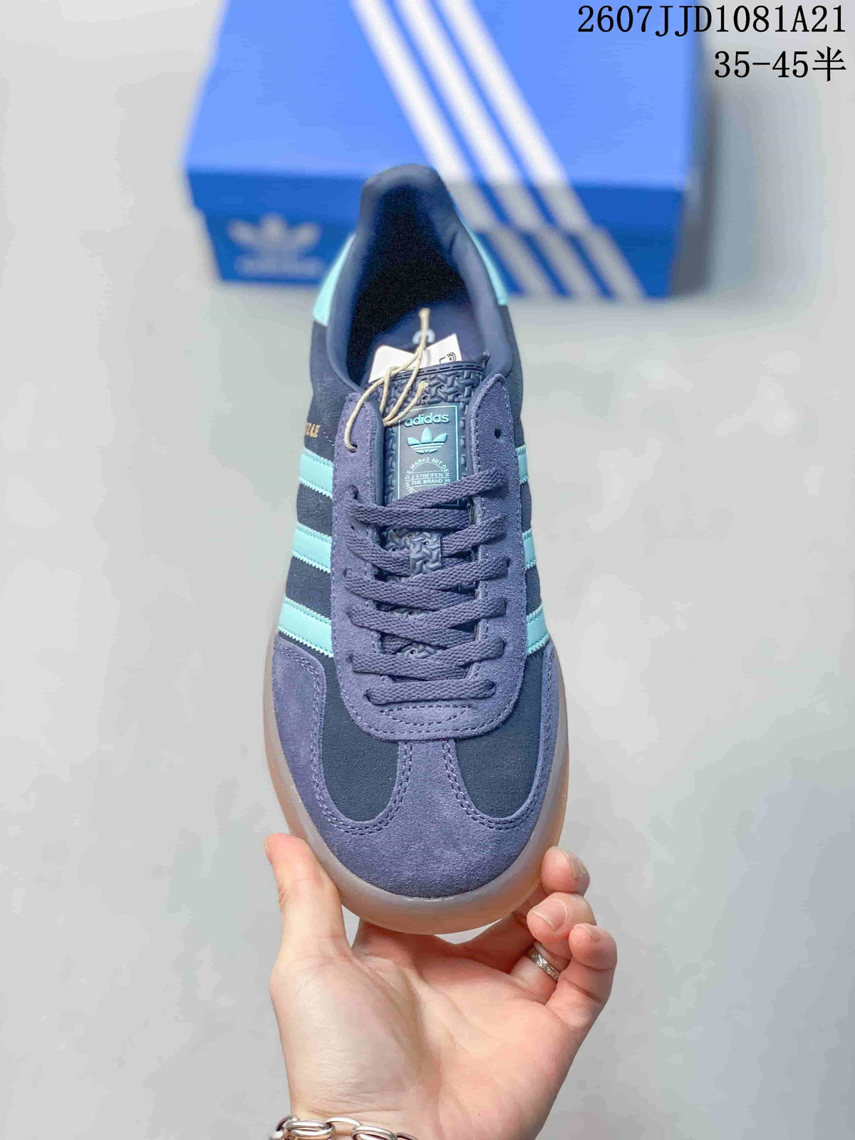 Top view showing the lace-up construction, padded collar, turquoise tongue branding, and contrasting toe panels.