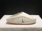 Side profile of a single light bone mule with the grey Swoosh and orange outsole pods visible.