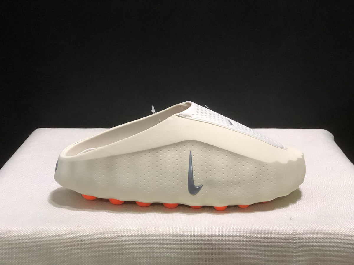 Side profile of a single light bone mule with the grey Swoosh and orange outsole pods visible.