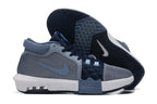 Gray and navy low-top basketball shoes shown from the side and outsole.