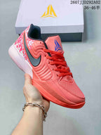 Coral Nike JA 2 basketball shoe with a dark Swoosh, blue tongue branding and patterned upper graphics.