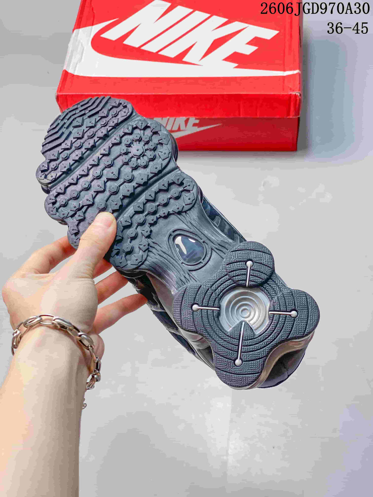 Underside of a Nike Shox TL sneaker showing its patterned outsole and heel unit