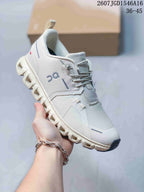 Angled side view of the white and grey On sneaker with visible branding, lace system and segmented outsole.