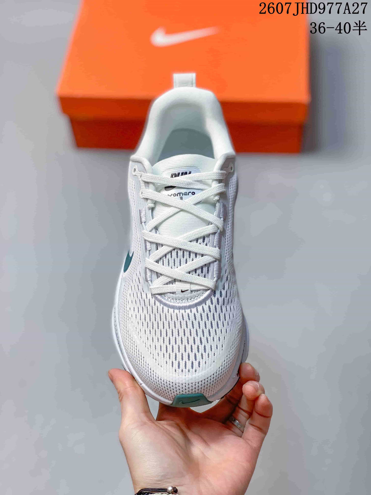 Top view of a white lace-up sneaker showing the perforated-looking mesh toe box, tongue and teal toe accent; overlay text shows style code 2607JHD977A27 and sizes 36–40.5.