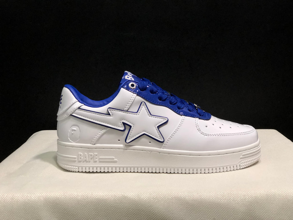 Side profile showing BAPE branding on the midsole, a white star-shaped side detail, blue trim, and a textured rubber outsole.