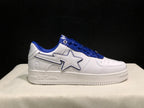 Side profile showing BAPE branding on the midsole, a white star-shaped side detail, blue trim, and a textured rubber outsole.