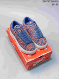 Blue and orange tiger-stripe Nike low-top sneakers displayed on a Nike shoebox.