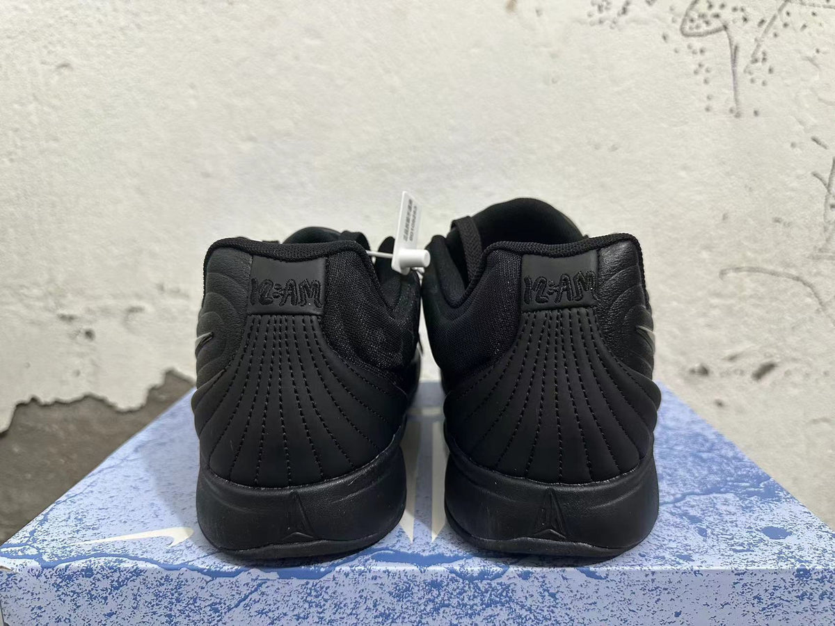Rear view of an all-black pair of Nike basketball shoes