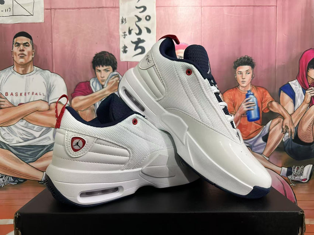 Angled view of two white Jordan sneakers highlighting the textured side panels, red details, and dark blue accents.