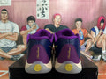 Rear view of purple and navy Nike basketball shoes with yellow heel details and visible “Freak” lettering.