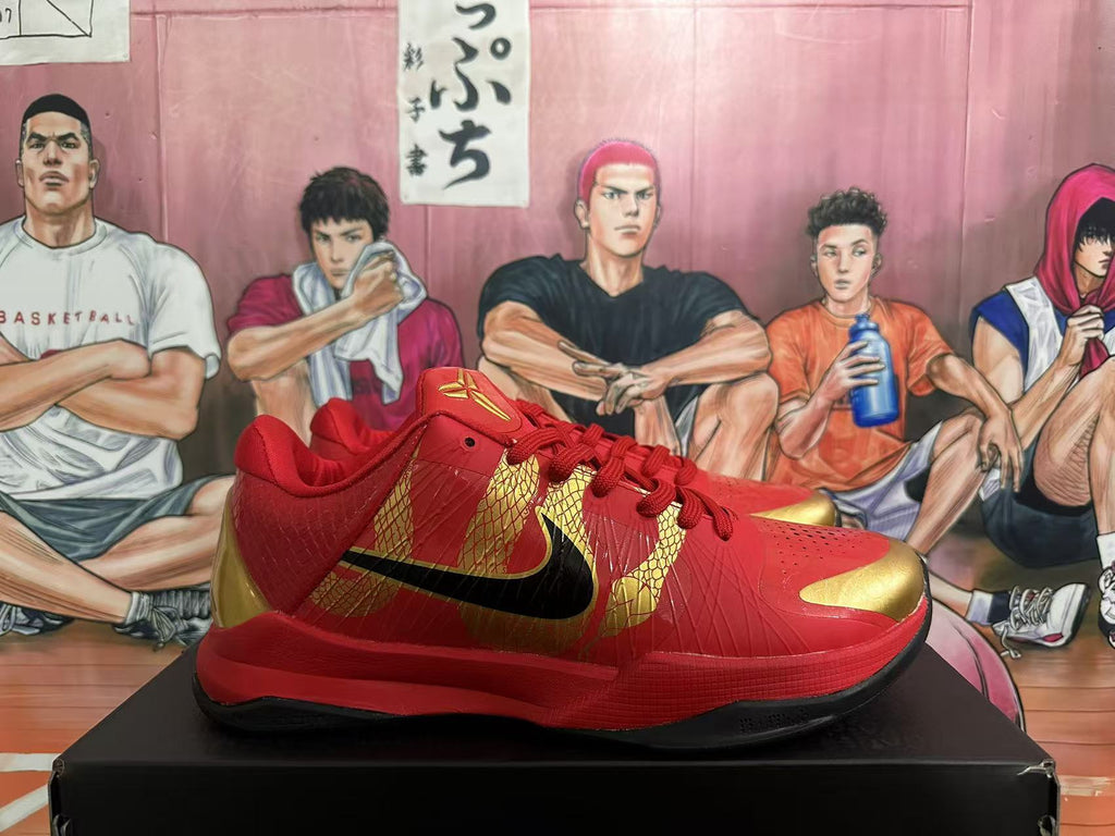 Side view of red basketball shoe with gold detailing and black Swoosh