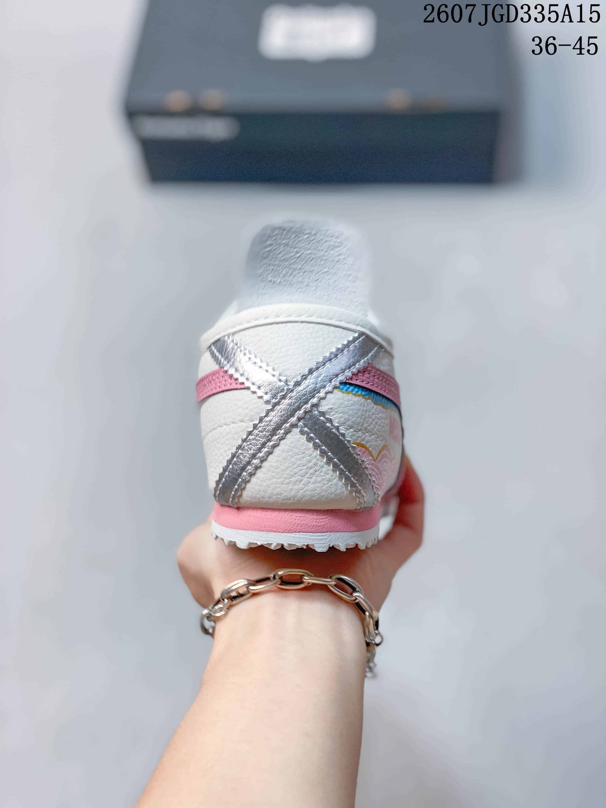 Rear view showing the white heel, pink heel trim, layered side detailing and textured outsole.