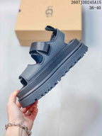 Side view of the black sandal showing its adjustable upper strap, open-toe construction, raised platform sole, and lugged outsole, with product code 2607JDD245A15 and size range 36–40 visible.