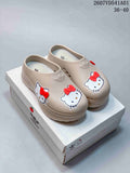Beige adidas x Hello Kitty mule clogs with red bow details shown on a branded box