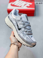 Side and three-quarter view of a white and silver Nike P-6000 sneaker with a dark Swoosh detail and textured sole.