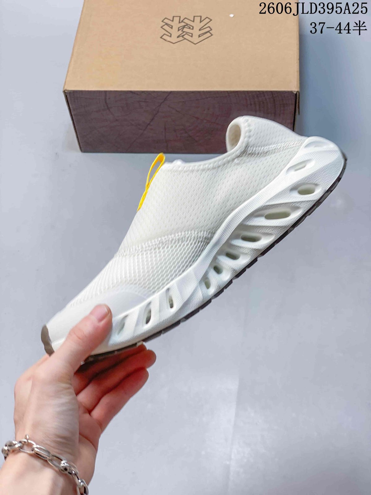 Side view of the white slip-on shoe with a sculpted sole and patterned upper.