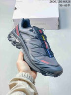 Angled side view of the gray shoe with a patterned upper and lugged sole
