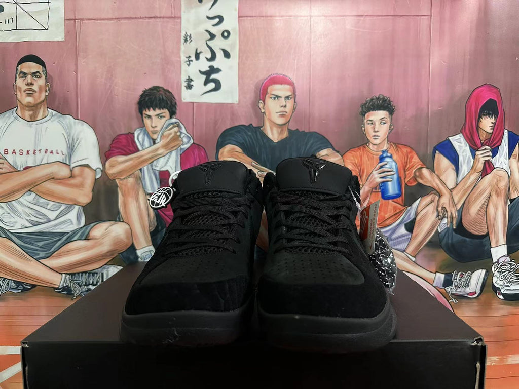 Front view of black low-cut basketball shoes with lace-up fronts and perforated toe panels