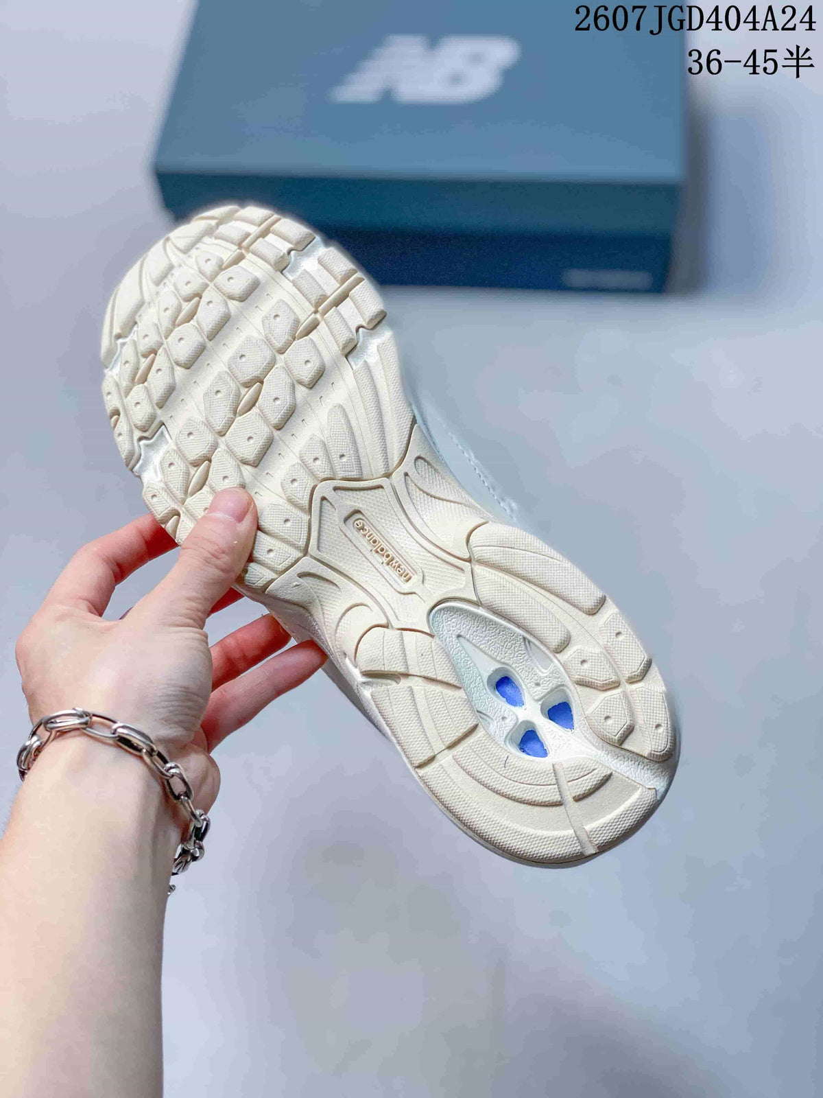 Underside view of a beige sneaker showing the segmented textured outsole.