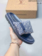 Side view of a blue Louis Vuitton Pool Pillow slide showing the monogram strap, decorative plaque, molded footbed, and textured outsole.