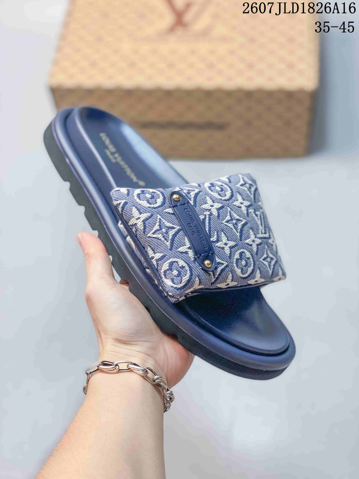 Side view of a blue Louis Vuitton Pool Pillow slide showing the monogram strap, decorative plaque, molded footbed, and textured outsole.