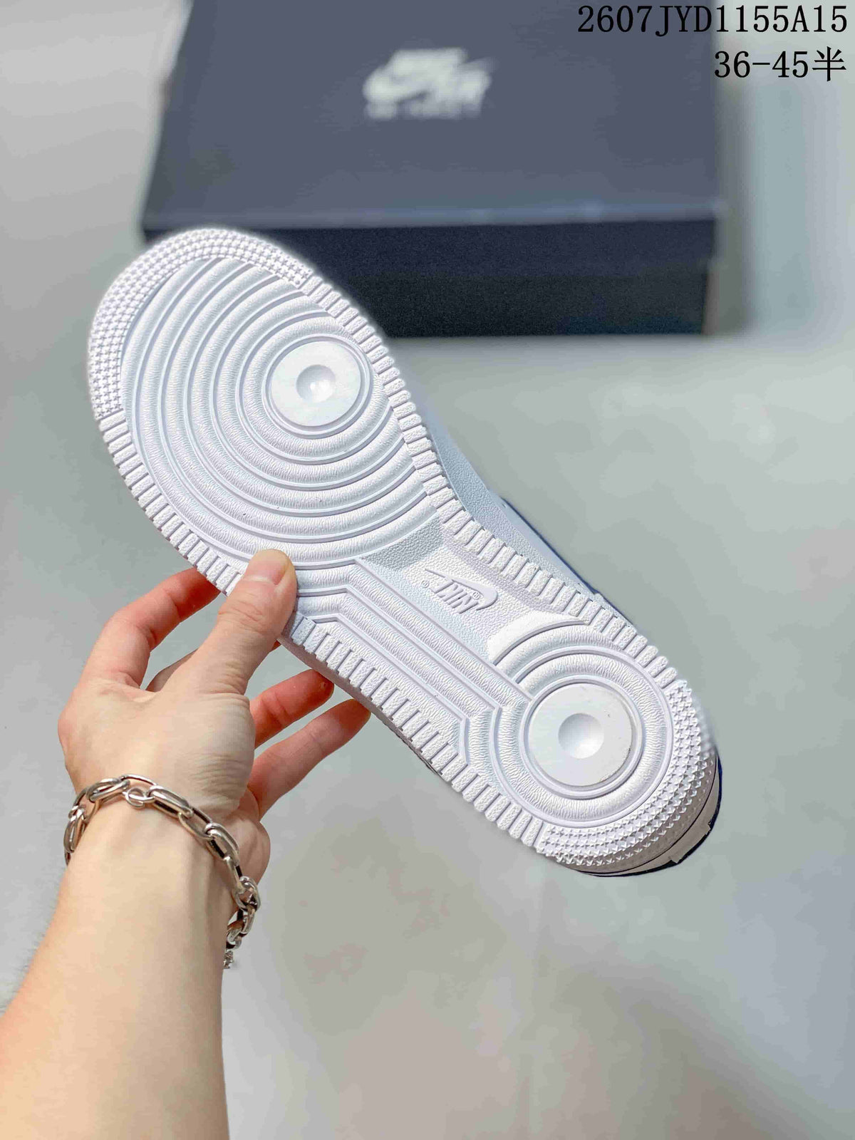 Underside view showing the white circular-groove outsole pattern and textured perimeter.
