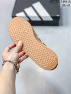 Close view of the textured gum-colored outsole with repeating geometric tread.