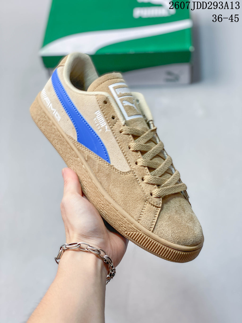 Angled side view of the tan and blue PUMA sneaker with its lace-up construction and rubber outsole.