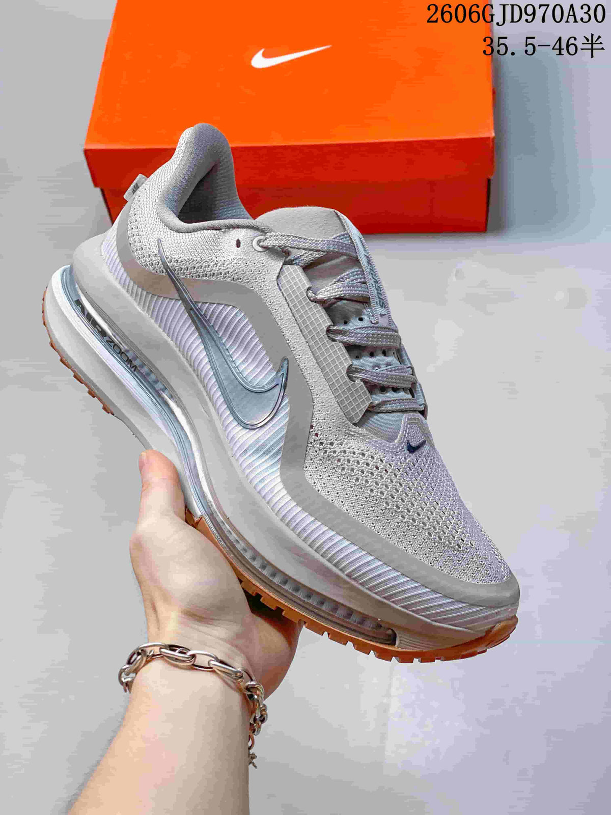 Light gray Nike Air Zoom Pegasus Premium sneaker with silver side Swoosh and brown outsole accents.