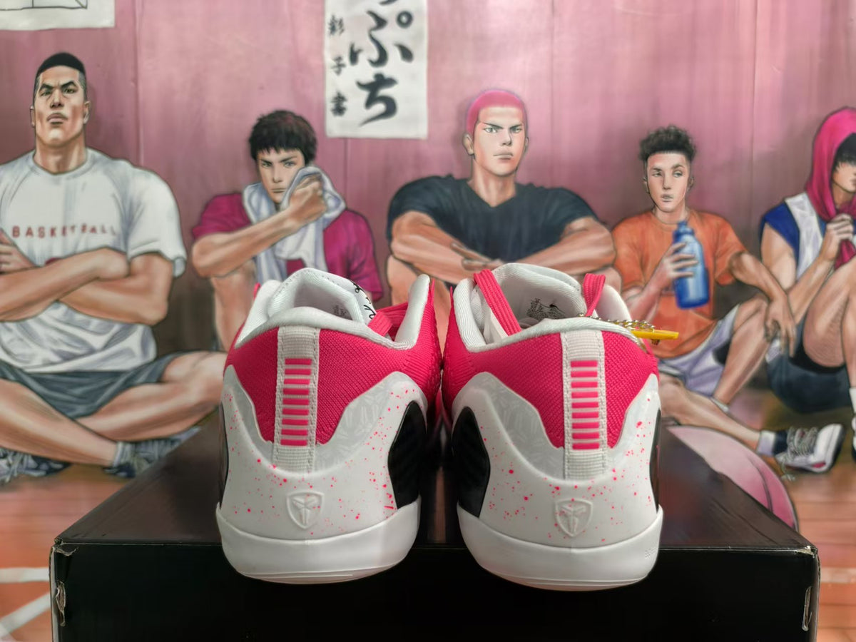 Rear view of pink and white Nike Kobe basketball shoes with speckled heel panels