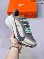 Angled side view of the gray Nike running shoe with mint laces, white midsole and dark Swoosh.