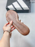 Close view of the brown outsole showing its textured tread pattern and adidas branding.