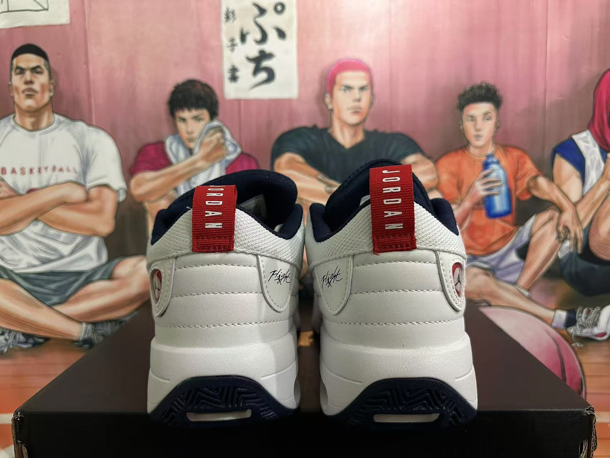 Rear view of white Jordan sneakers with dark blue heel accents and red pull tabs.