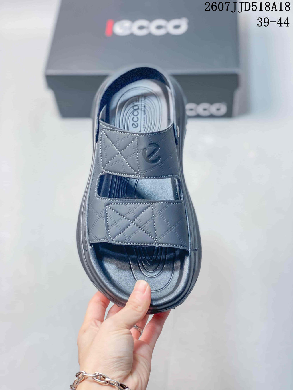 Top view of the black sandal showing the contoured footbed and two geometric-detail straps.